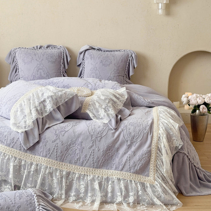 Romantic bedding set with lace trim, ruffle, and quilted blanket