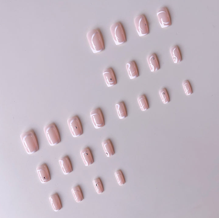 Artificial nail set with elegant French tips and glamorous rhinestone decorations Stornfield