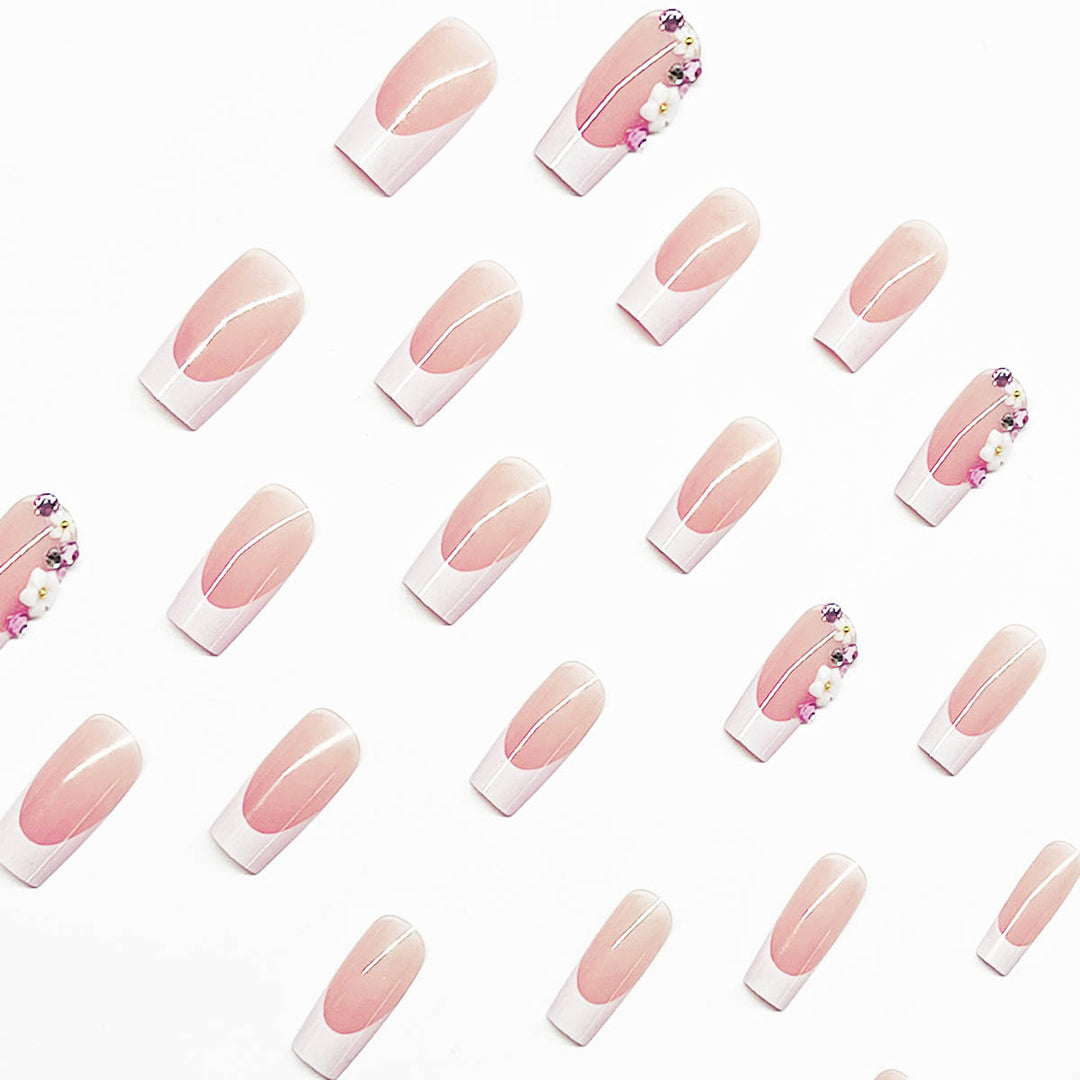 Artificial nail set with elegant floral decorations and transparent finish Stornfield