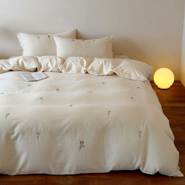 Breathable cotton bedding set with delicate flower embroidery and tie ribbon pillow