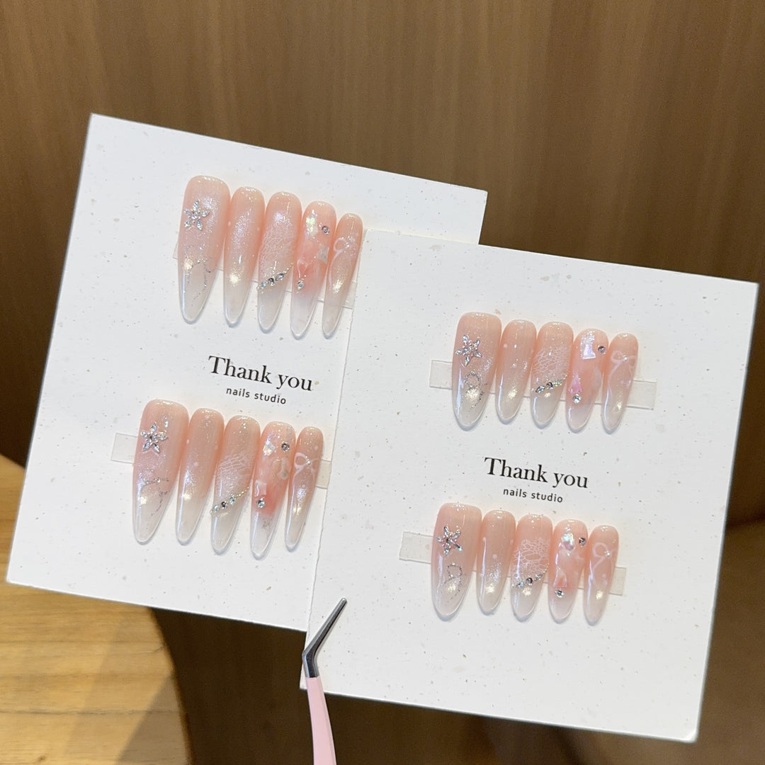 Artificial nails with filigree design and glitter accents Stornfield