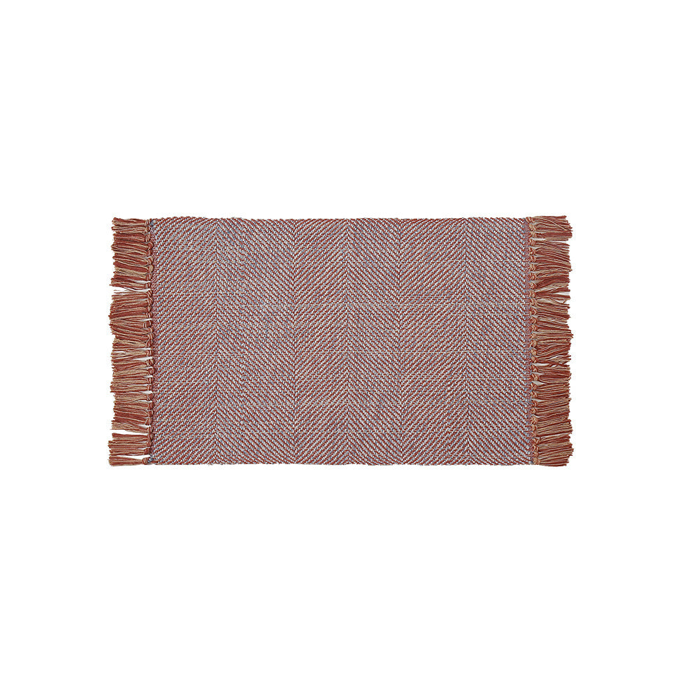 Handwoven table runner in herringbone pattern with decorative fringes