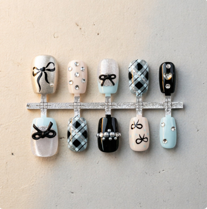 Artificial nails with elegant bows and rhinestones Stornfield