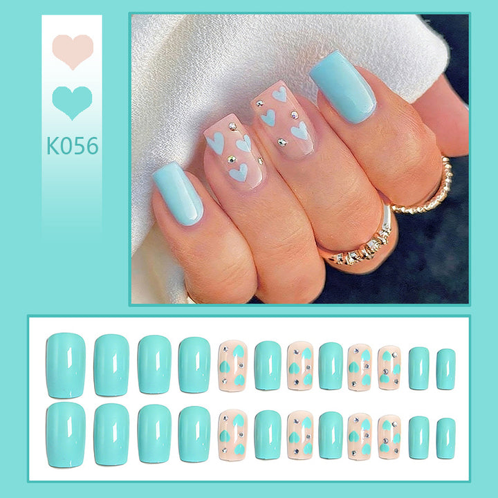 Nail art with heart designs and glitter accents Stornfield
