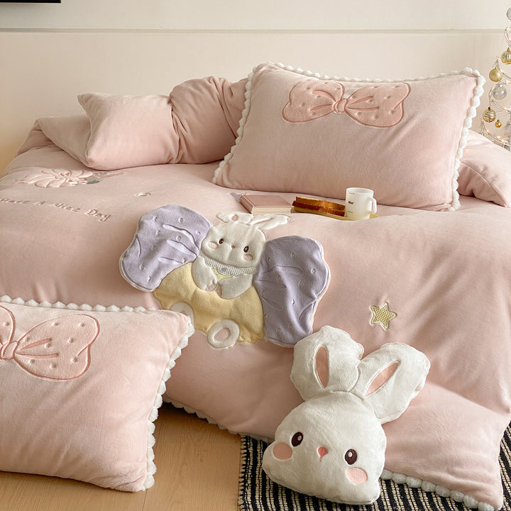 Cozy quilted bedding set with plush appliqué and pompom trim