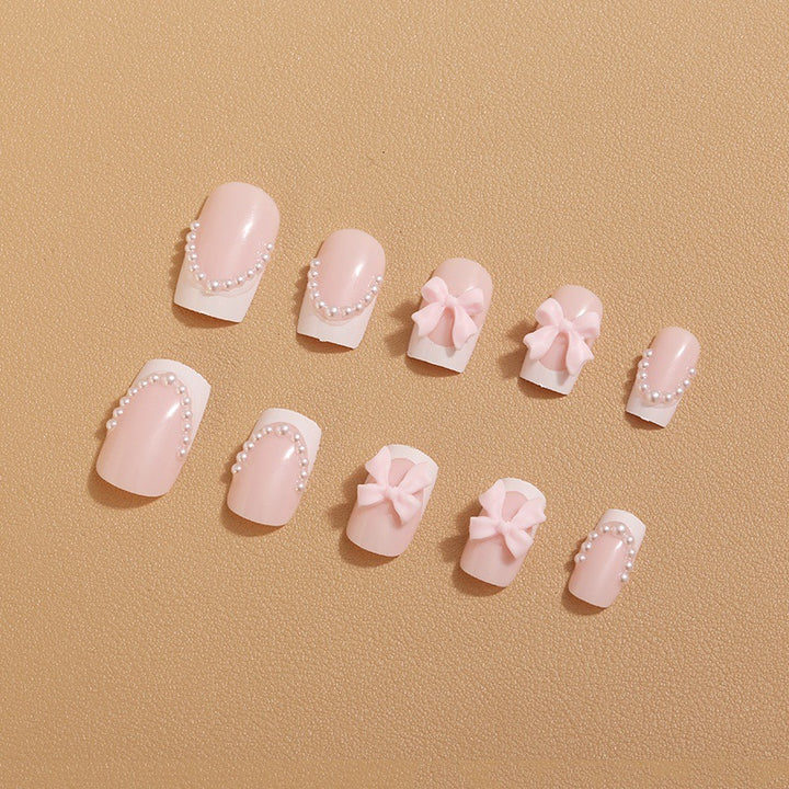 Artificial nail tips with elegant bows and pearl decorations Stornfield