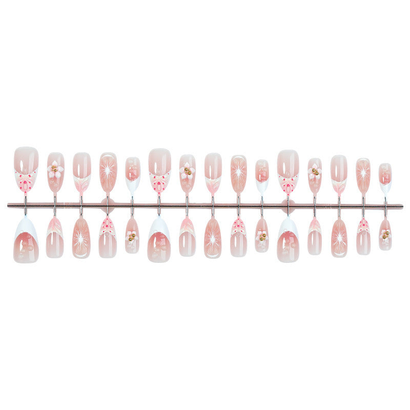 Creative acrylic nail set with floral accents and glitter decorations Stornfield