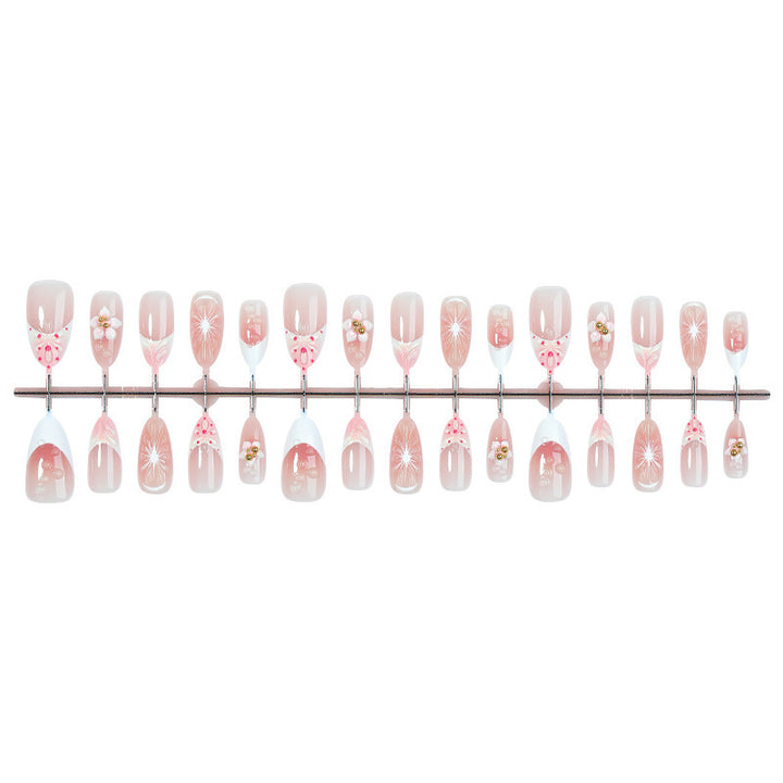 Creative acrylic nail set with floral accents and glitter decorations Stornfield