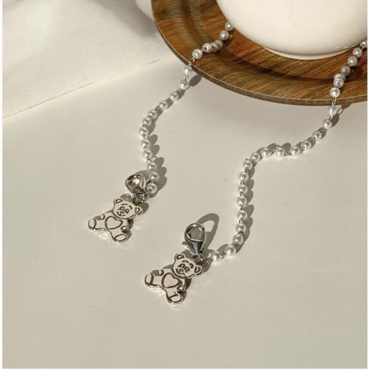 Playful pearl necklace with gold pendants Stornfield