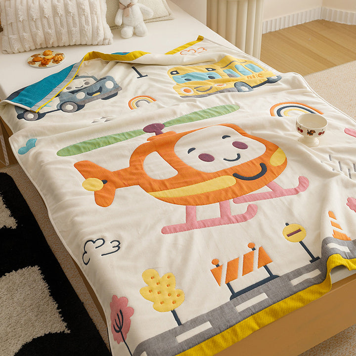 Kids' cuddly blanket with cheerful vehicle print made of soft microfibre