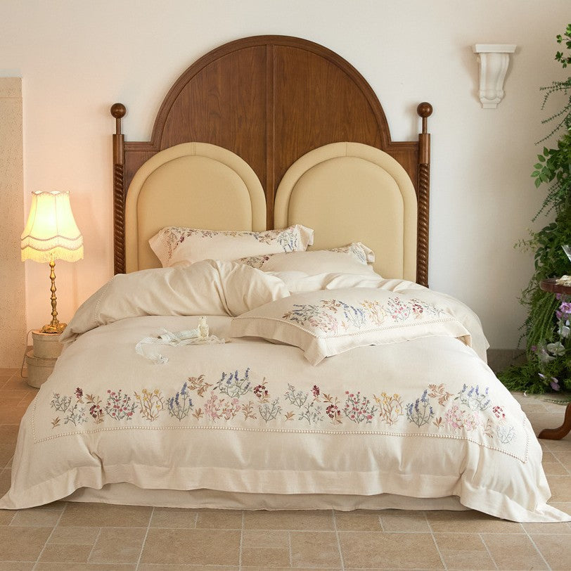 Romantic cotton satin duvet cover set with delicate floral embroidery and decorative pillow