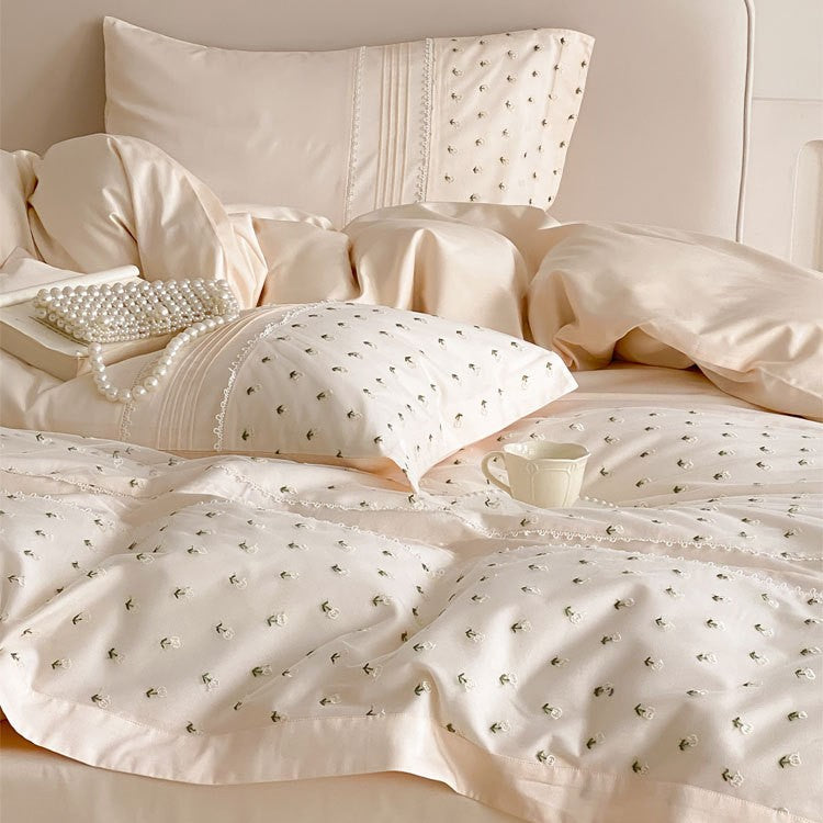Exclusive satin bedding set with all-over rosebud embroidery and pleating details
