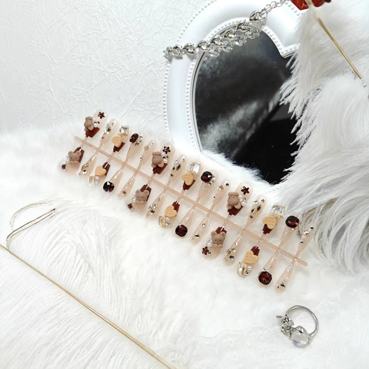 Creative acrylic nails with animal motifs and glitter accents Stornfield