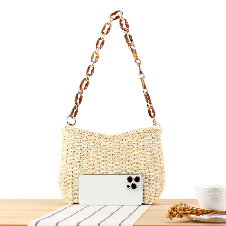Stylish handbag made of woven natural material with exclusive chain accents Stornfield