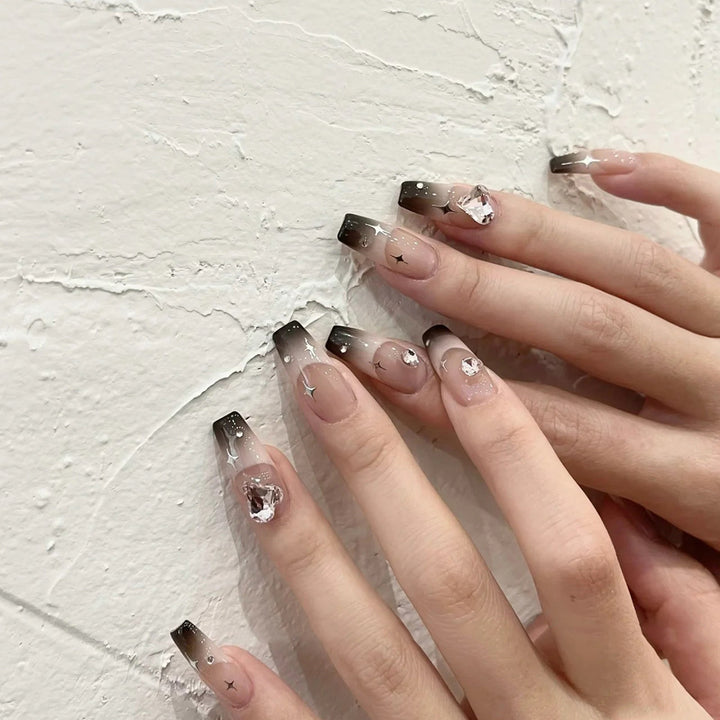 Artificial nail extensions with elegant ombre design and glitter accents Stornfield