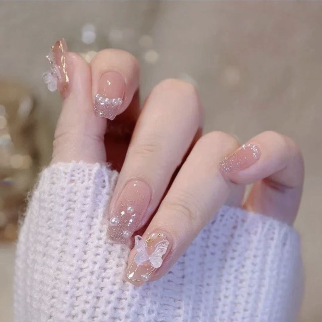 Artistic Nail Art with Glitter and Flower Applications Stornfield