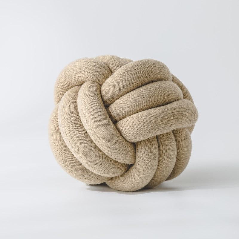 Decorative knitted knot cushion as a decorative pillow made of soft jersey
