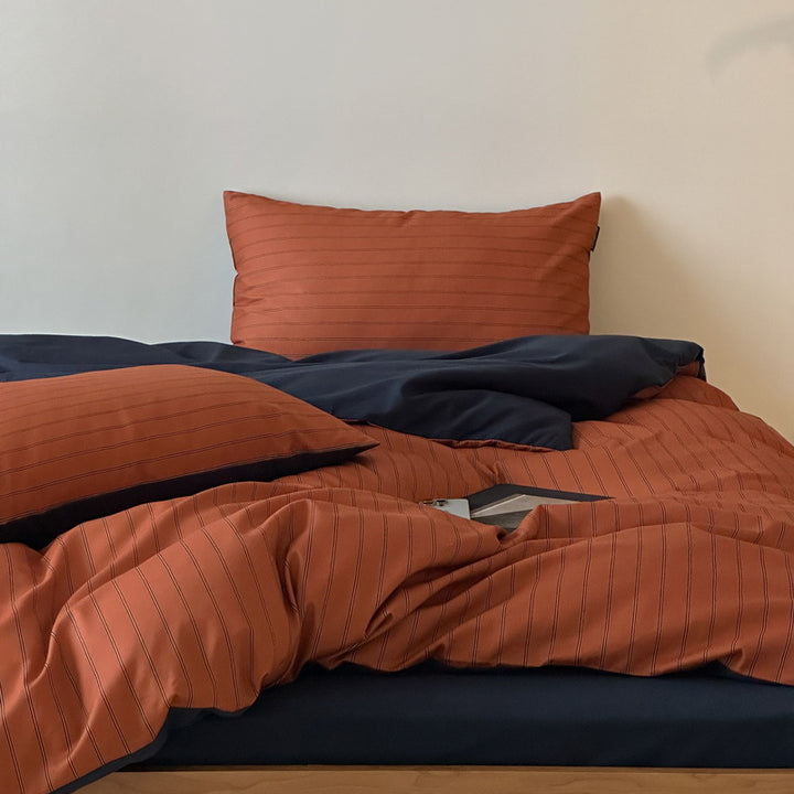 Reversible cotton satin bedding set with fine striped pattern and contrasting backside