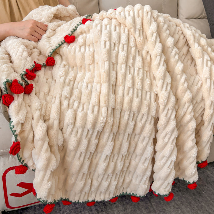 Cuddly blanket with crocheted rose trim and plush texture
