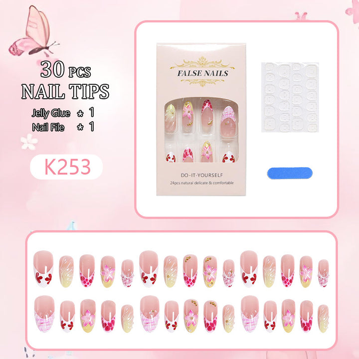 Artificial nails with floral accents and glitter decorations Stornfield