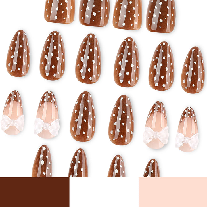 Artistic stiletto nails with delicate bow motif Stornfield