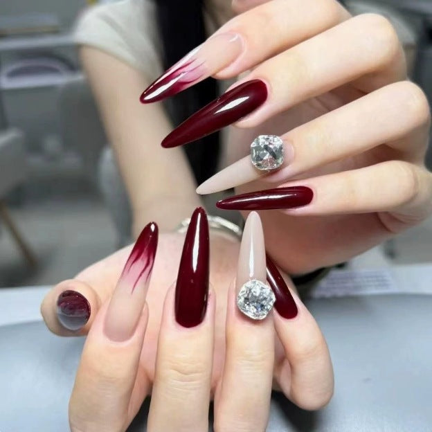 Elegant Stiletto Nail Enhancements with Gem Accents Stornfield