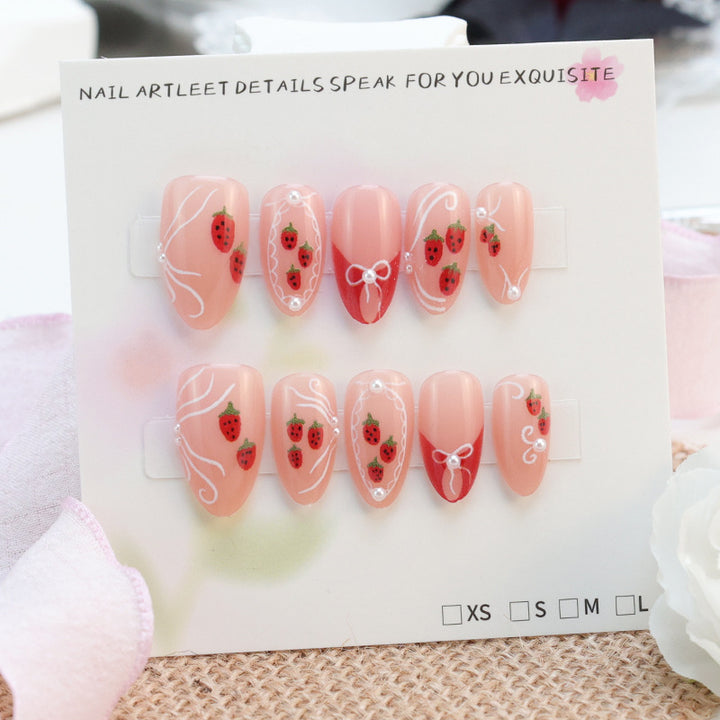 Artificial nail set with romantic strawberry and bow motifs Stornfield
