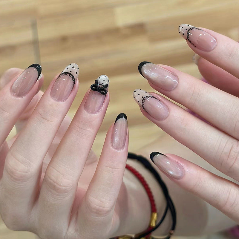 Artistic French Tip Nail Design with Bow Embellishments Stornfield