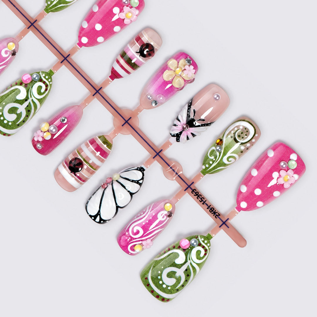 Artificial nail set with playful floral and glitter motifs Stornfield