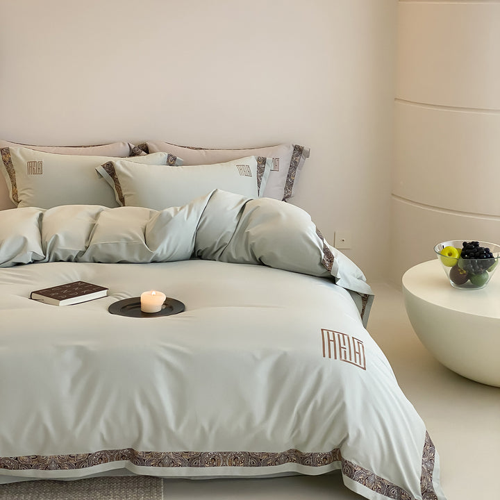 Luxurious bedding set made of cotton satin with paisley border and monogram embroidery