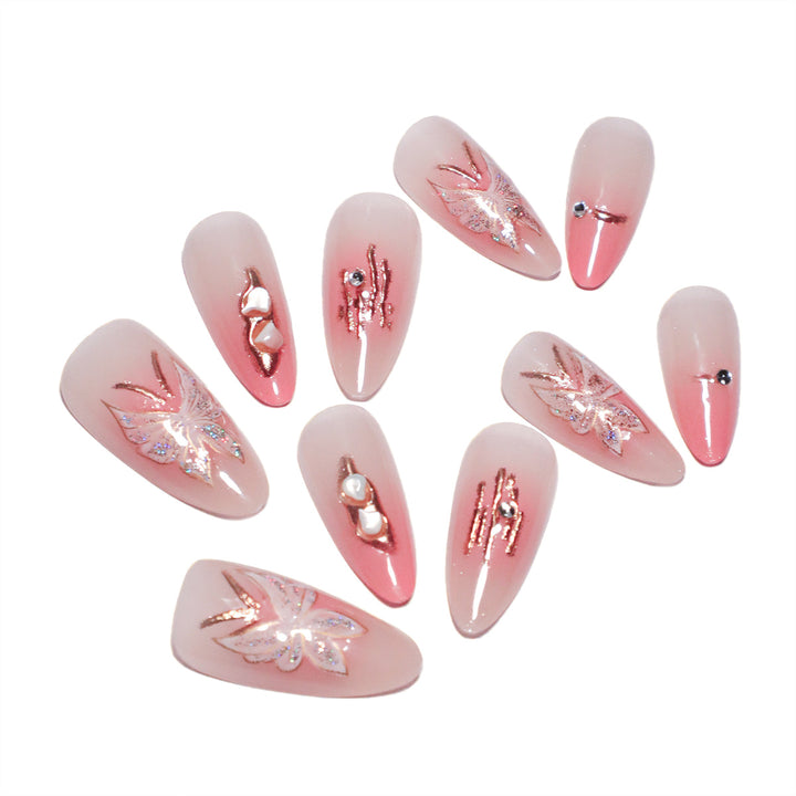 Artificial nail extensions with floral motifs and glitter accents Stornfield