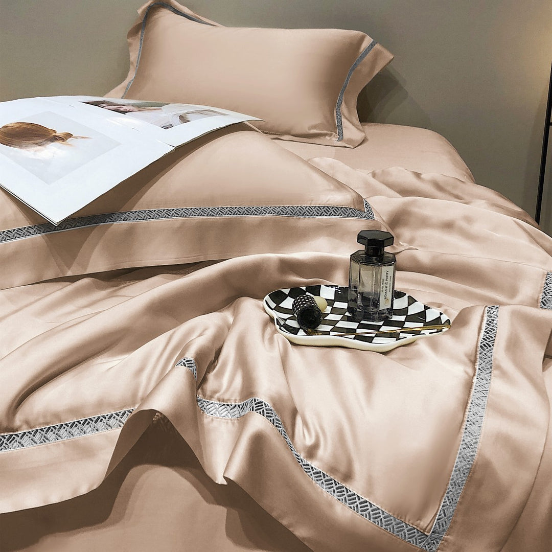 Luxurious satin bedding set with fine embroidered border and tone-on-tone floral relief