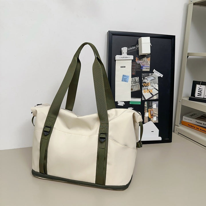 Sporty shoulder bag with water-repellent material and sturdy carrying handles Stornfield