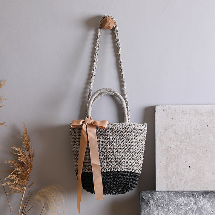 Basket bag with stylish carrying handles and decorative bow Stornfield