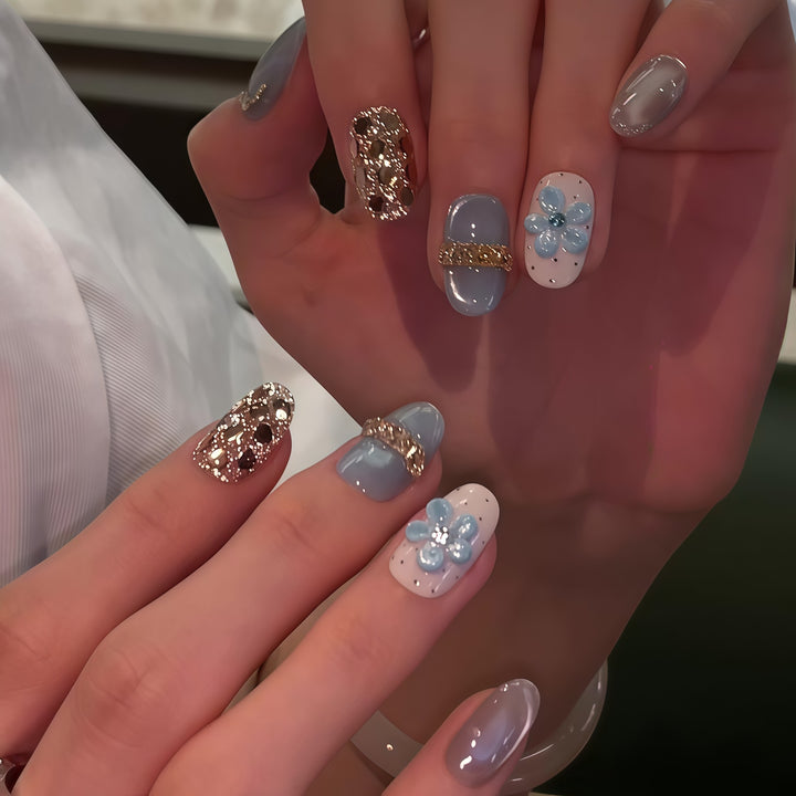 Artificial nails with luxurious glitter details and floral accents Stornfield