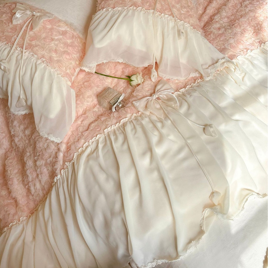 Romantic bedding set with ruffled edges, frills, and decorative accent pillows