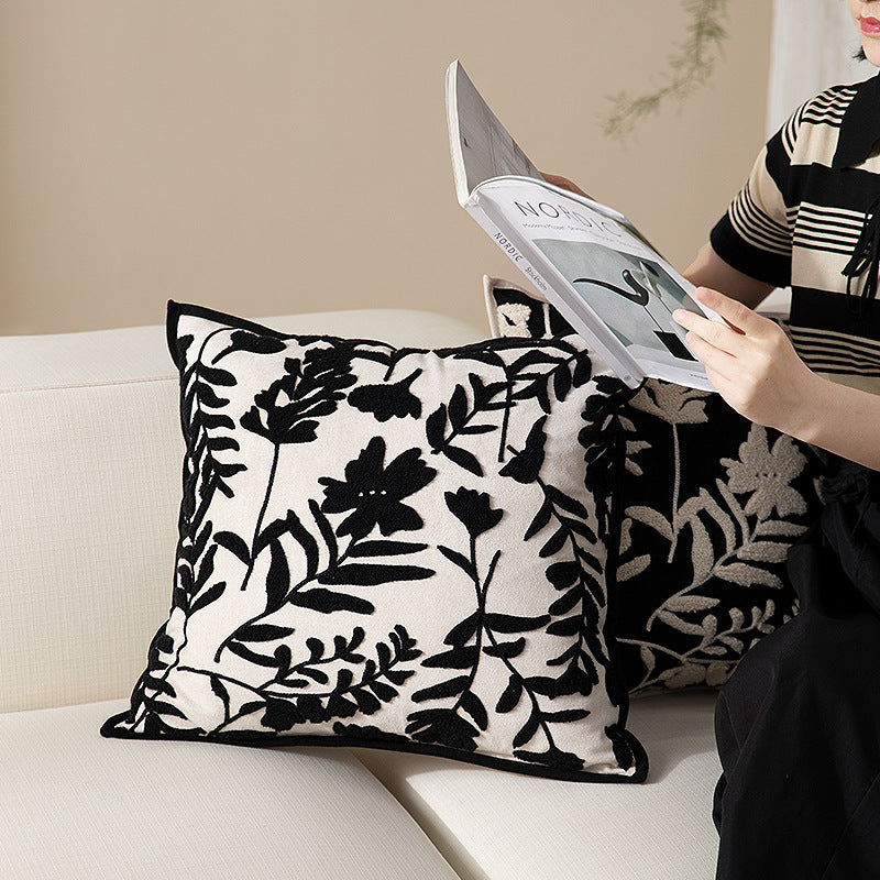 Square decorative pillow with floral flock embroidery and fine piping edge