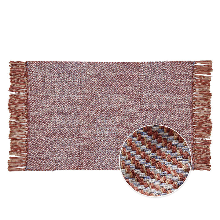 Handwoven table runner in herringbone pattern with decorative fringes