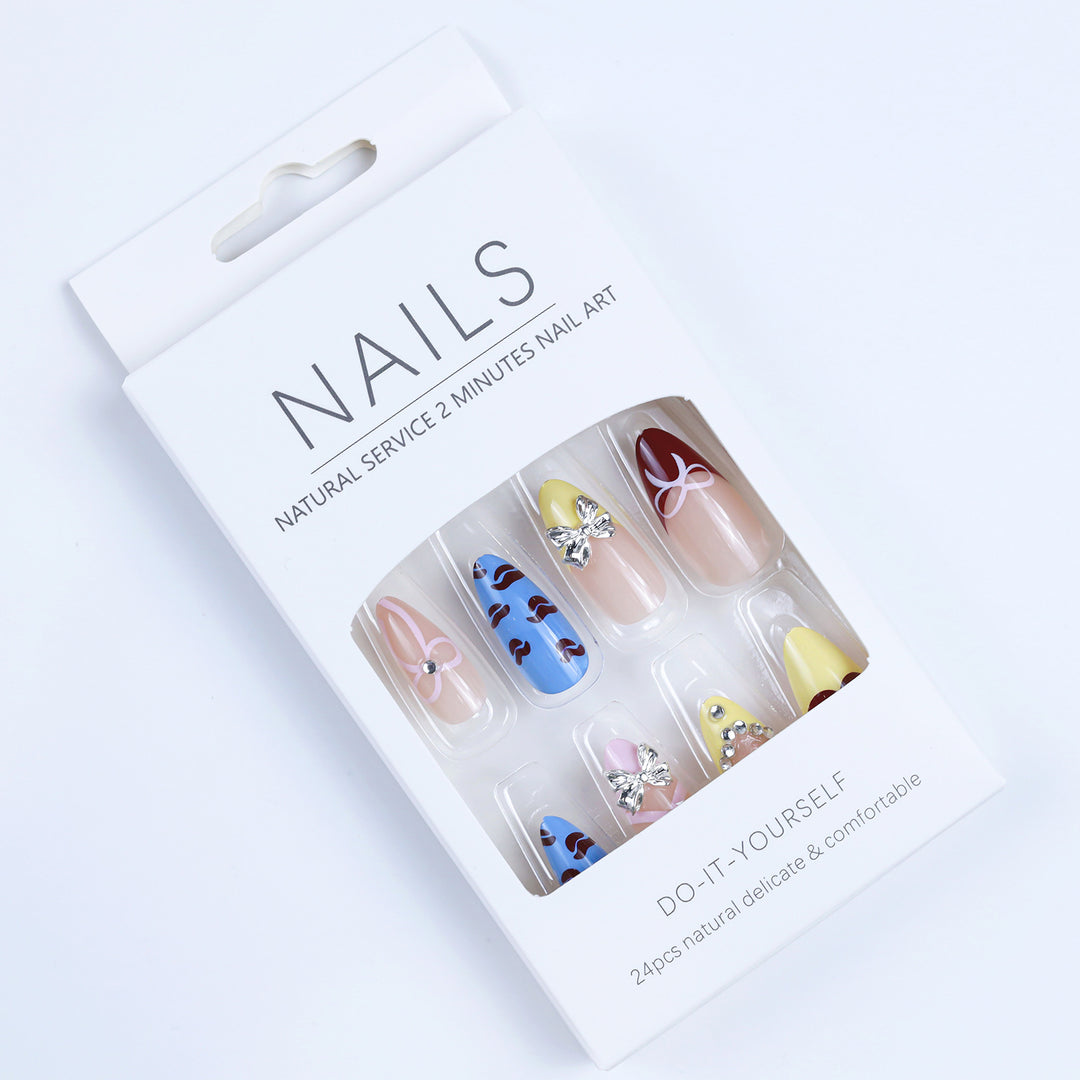 Artificial nails with playful design and 3D embellishments Stornfield