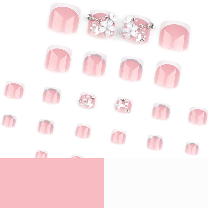 Artful toenail design with elegant flower and glitter accents Stornfield