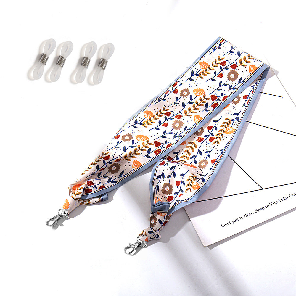 Fashionable fabric mask holder with floral motifs Stornfield