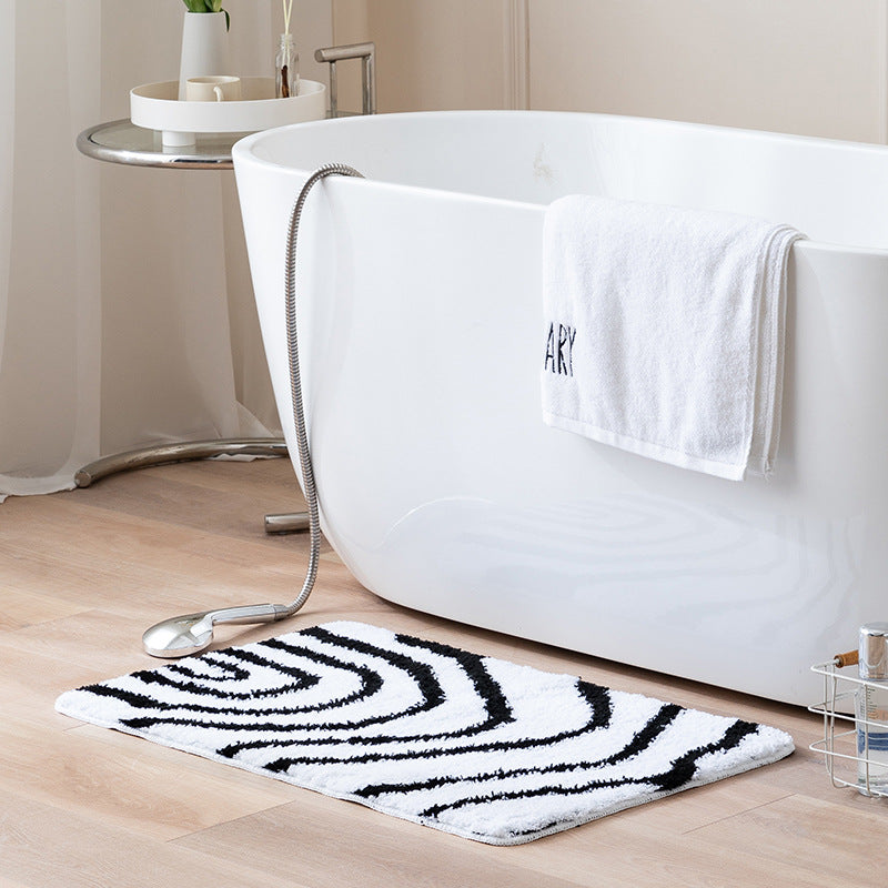 Fluffy bath mat in a graphic wave relief with anti-slip base Stornfield