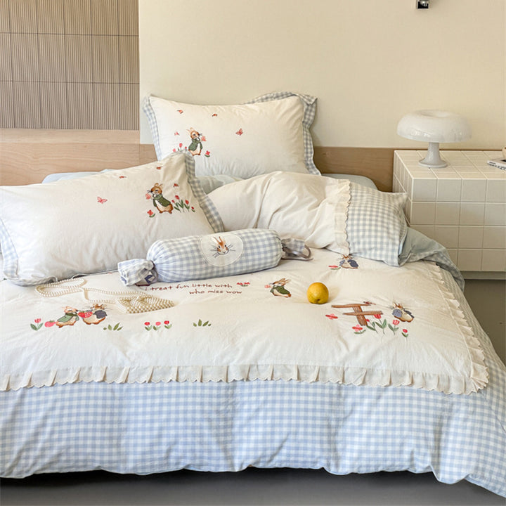 Romantic bedding set with embroidered rabbit motifs and delicate ruffles