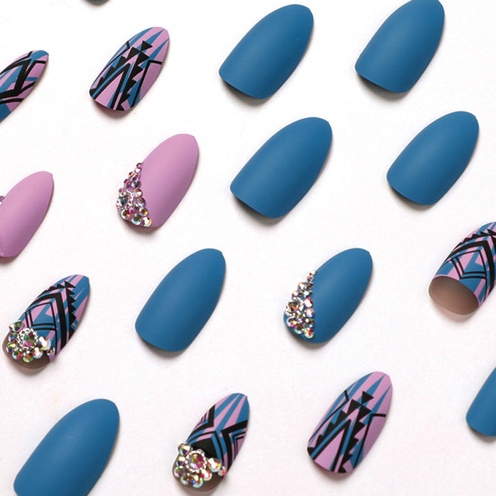 Artful stiletto nails with modern geometric designs and rhinestone embellishments Stornfield