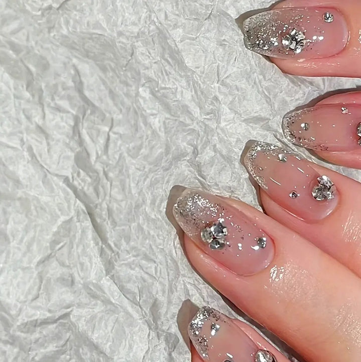 Glamorous artificial nails with glitter and rhinestone embellishments Stornfield