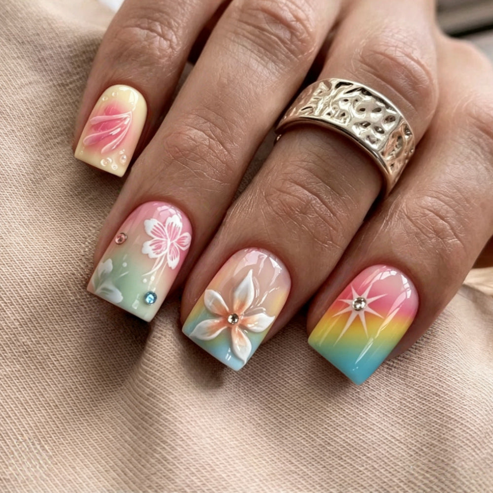 Artificial nails in vibrant floral design with glitter accents Stornfield