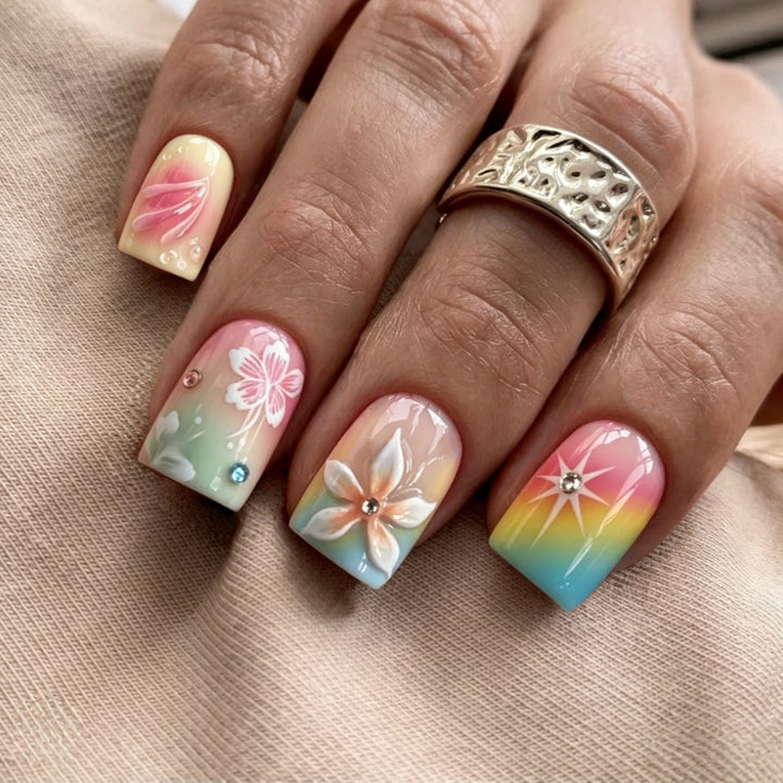 Artificial nails in vibrant floral design with glitter accents Stornfield