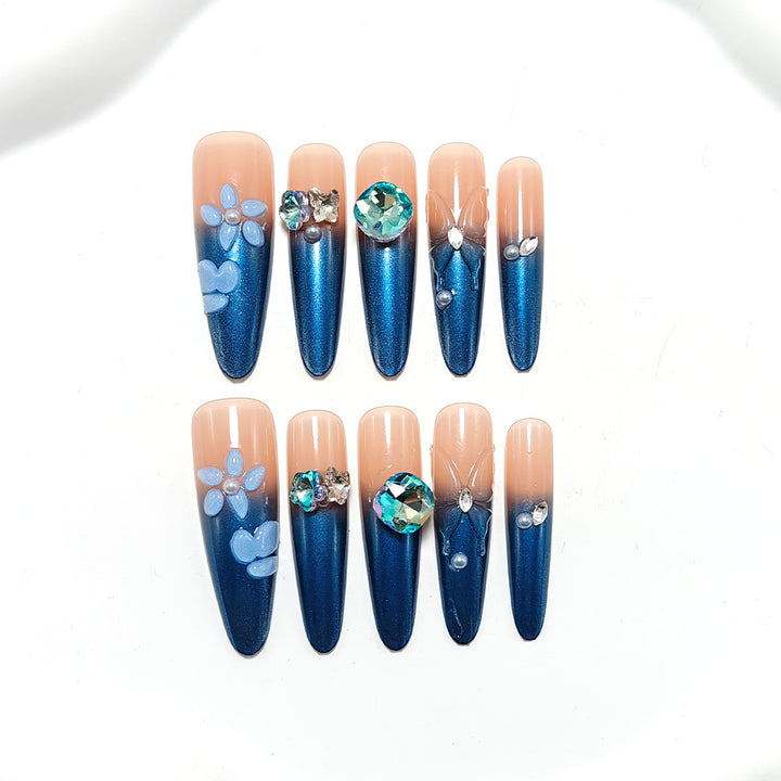 Artificial nails in elegant design with artistic decorations and glitter accents Stornfield