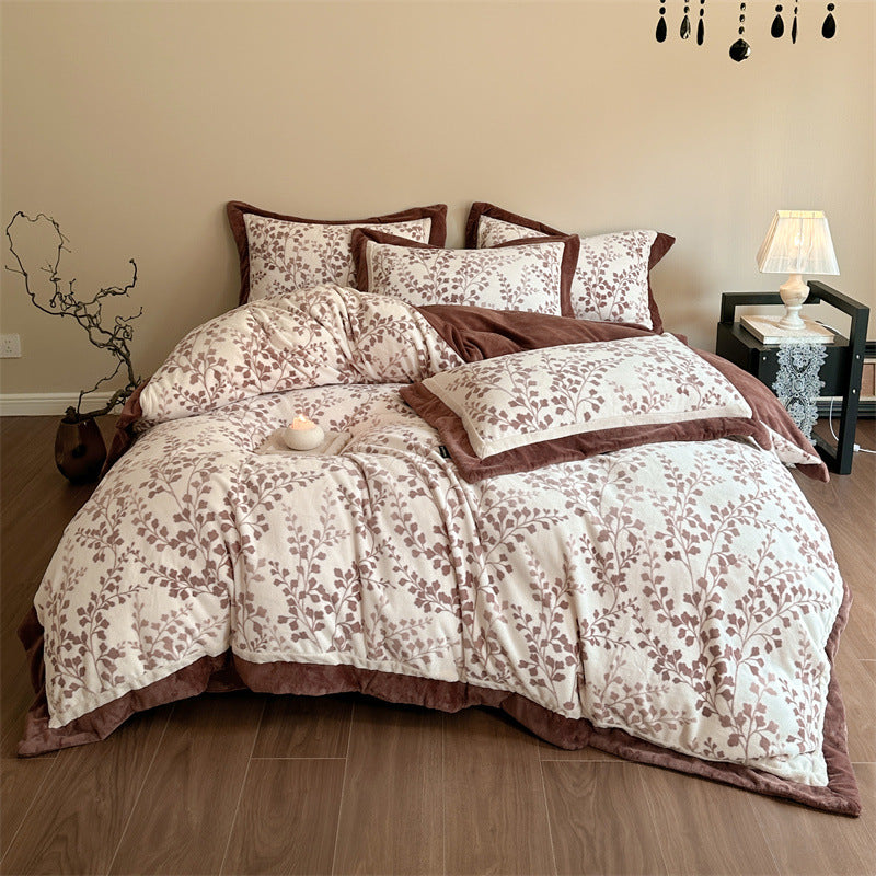 Luxurious quilted bedding set with velvet trim and floral branch motif