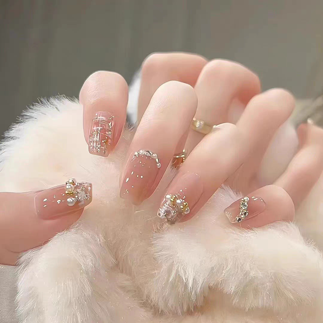 Artificial nails with elegant pearl and glitter decorations Stornfield